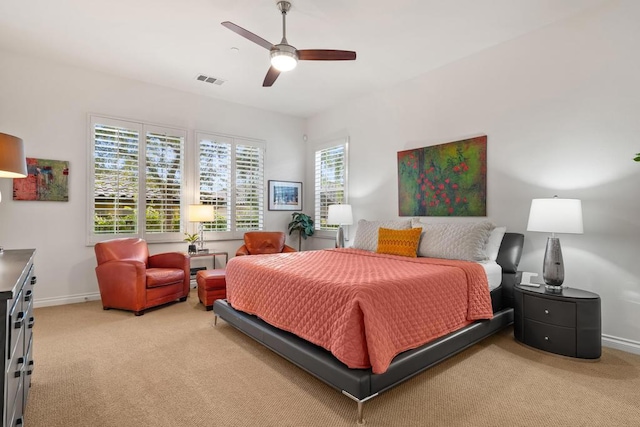 bedroom featuring ceiling fan and light carpet