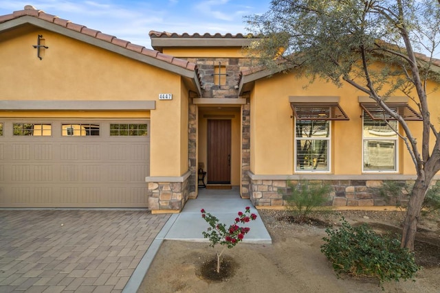 view of exterior entry featuring a garage