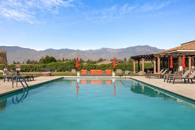 view of pool featuring a mountain view and a patio area