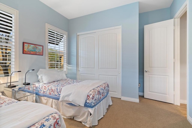 bedroom featuring light carpet and a closet