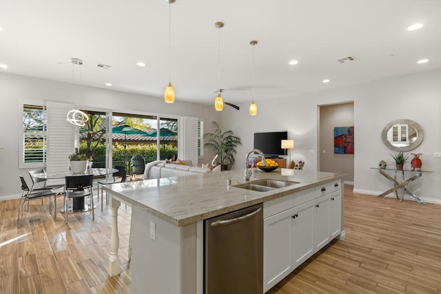 kitchen featuring dishwasher, white cabinetry, sink, hanging light fixtures, and a kitchen island with sink