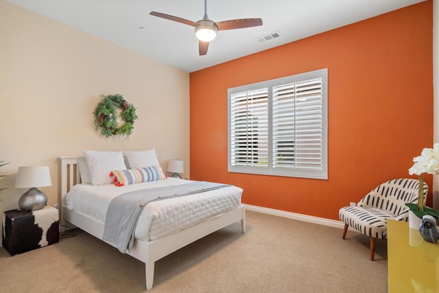 bedroom with ceiling fan and light carpet