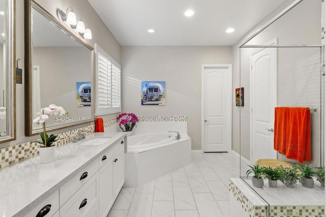 bathroom with a relaxing tiled tub and vanity