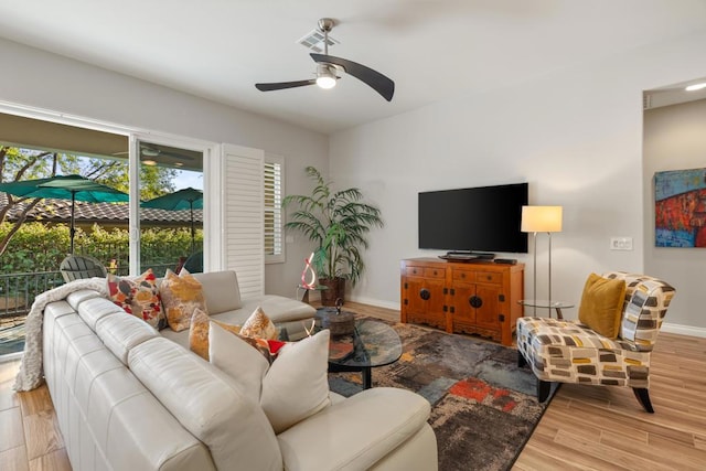 living room featuring ceiling fan and light hardwood / wood-style flooring