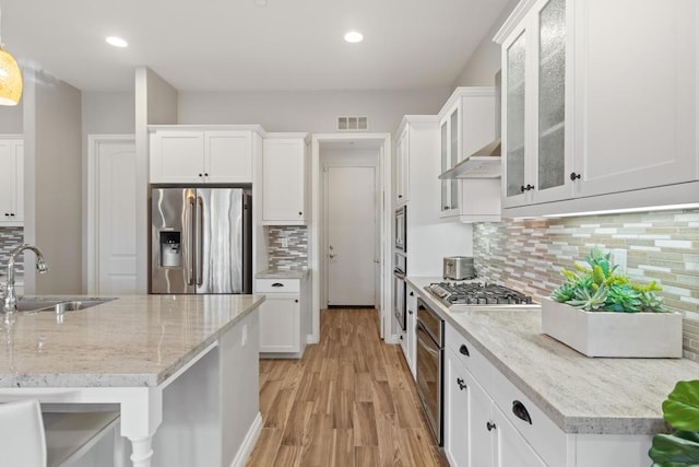 kitchen featuring decorative backsplash, sink, white cabinets, and stainless steel appliances