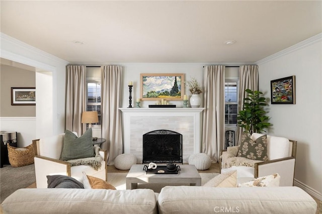 carpeted living room with crown molding and a fireplace