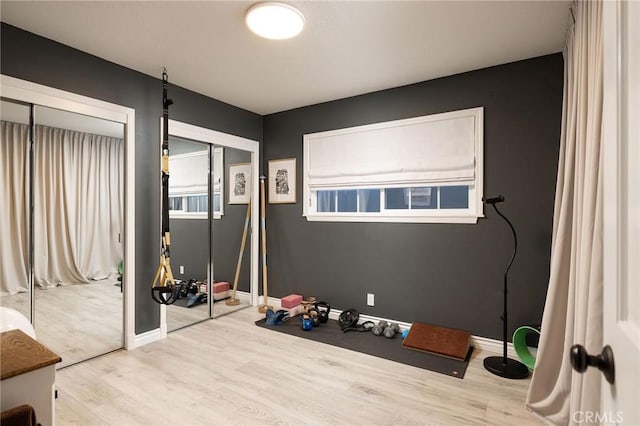 interior space featuring two closets and hardwood / wood-style floors