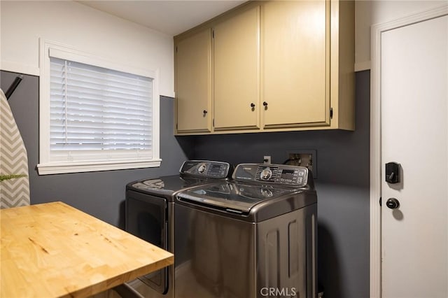 washroom with cabinets and separate washer and dryer