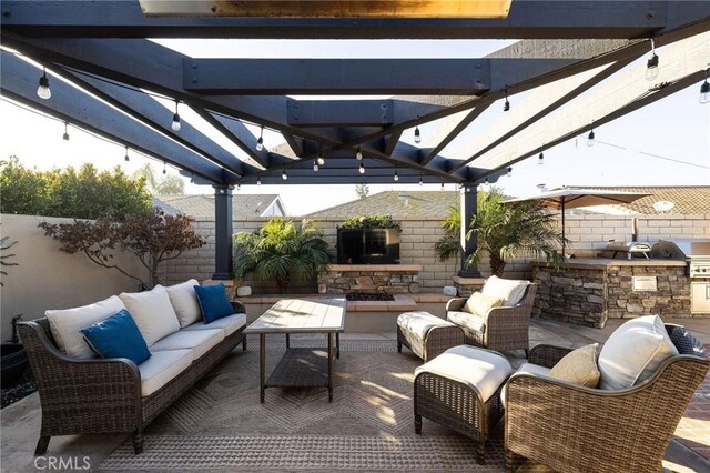 view of patio with exterior kitchen, outdoor lounge area, a grill, and a pergola