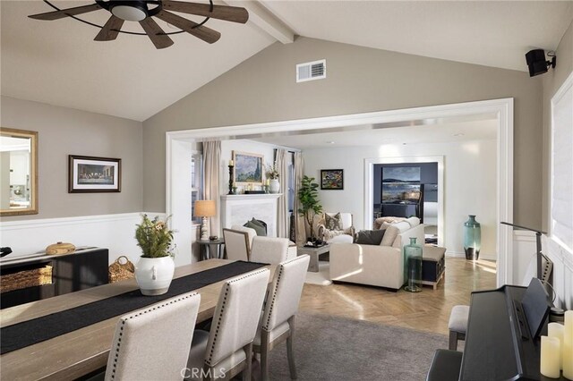 dining area with ceiling fan and lofted ceiling with beams