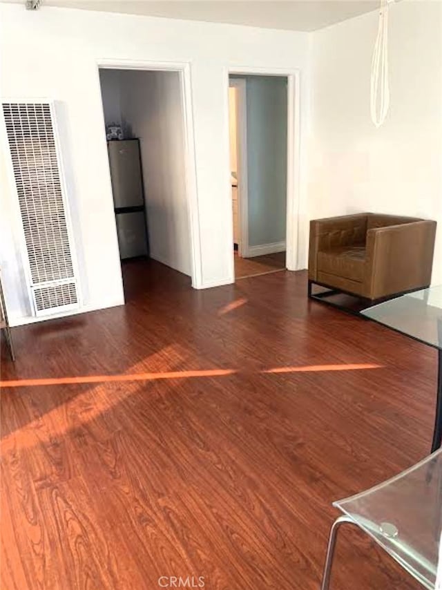 unfurnished living room featuring dark wood-type flooring