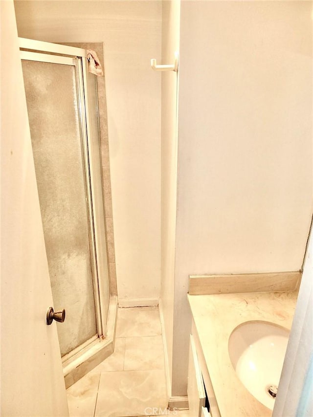 bathroom with vanity, tile patterned flooring, and a shower with door