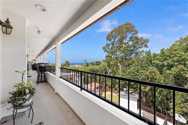 balcony featuring a water view