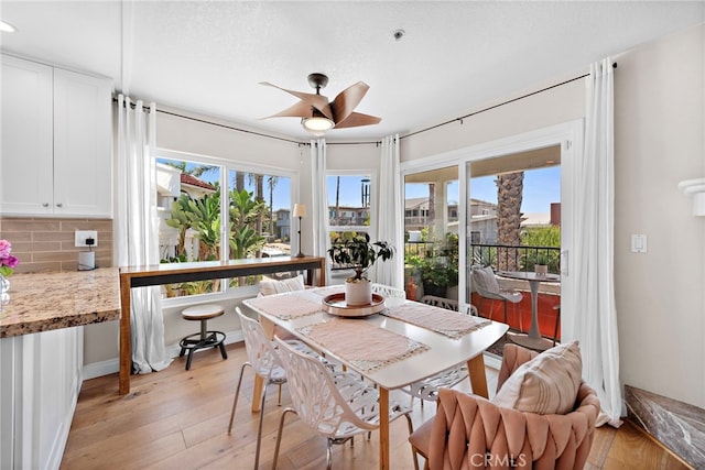 dining space featuring ceiling fan, a textured ceiling, and light hardwood / wood-style floors