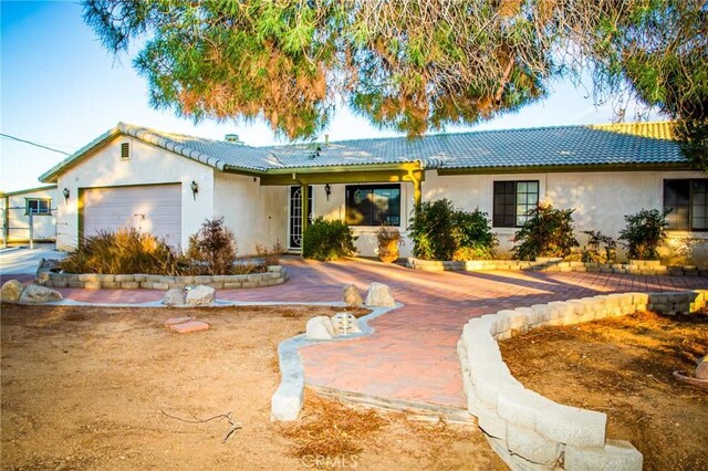 ranch-style home featuring a garage