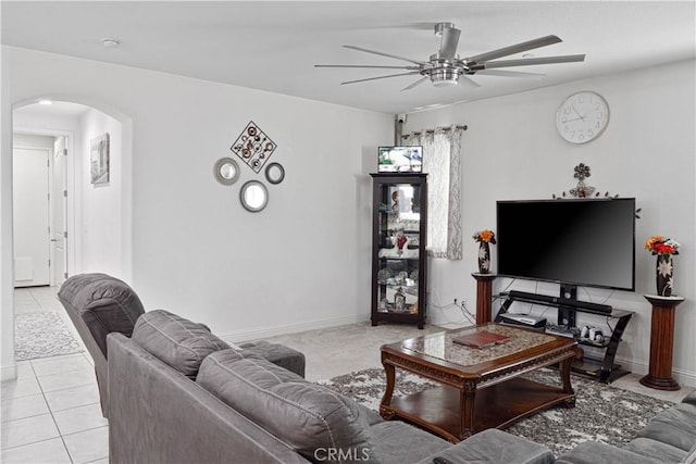 1714 Graybark Ave, Clovis, CA 93619 - living room with arched walkways, light tile patterned floors, baseboards, and a ceiling fan