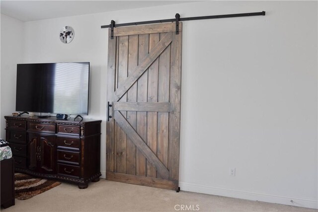 1714 Graybark Ave, Clovis, CA 93619 - bedroom featuring carpet floors, baseboards, and a barn door
