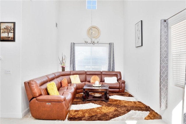 1714 Graybark Ave, Clovis, CA 93619 - living room with a towering ceiling, a notable chandelier, baseboards, and a wealth of natural light