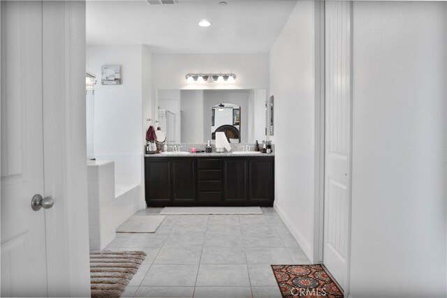 1714 Graybark Ave, Clovis, CA 93619 - full bathroom with baseboards, double vanity, tile patterned floors, visible vents, and a garden tub