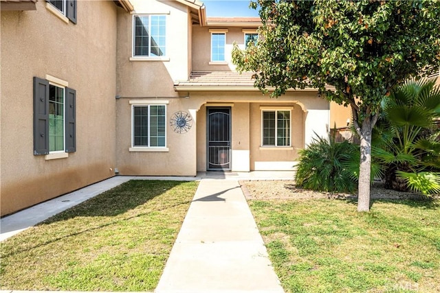 1714 Graybark Ave, Clovis, CA 93619 - doorway to property with stucco siding, a lawn, and a tile roof