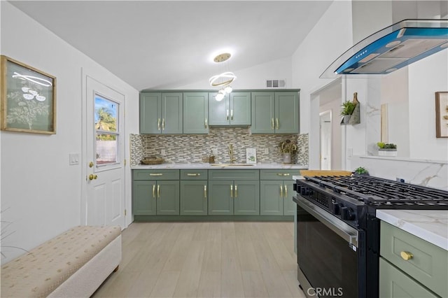 kitchen with green cabinetry, island exhaust hood, black gas range oven, light stone countertops, and vaulted ceiling