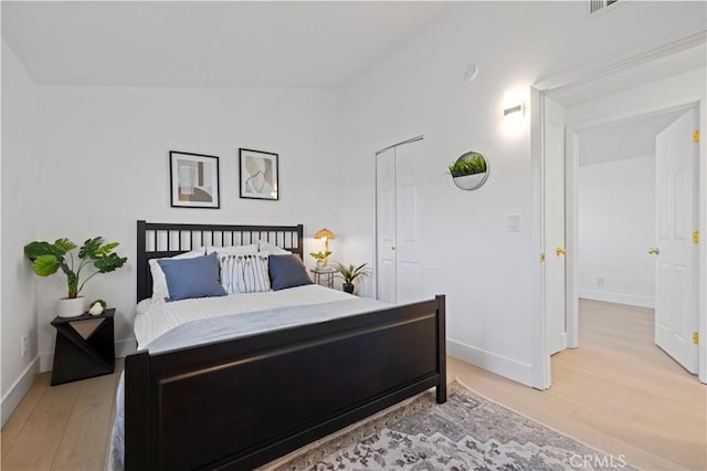 bedroom featuring vaulted ceiling and hardwood / wood-style floors