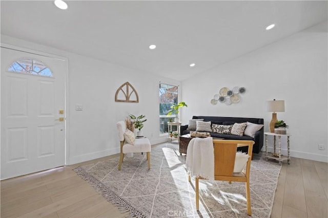 living room with lofted ceiling and light wood-type flooring