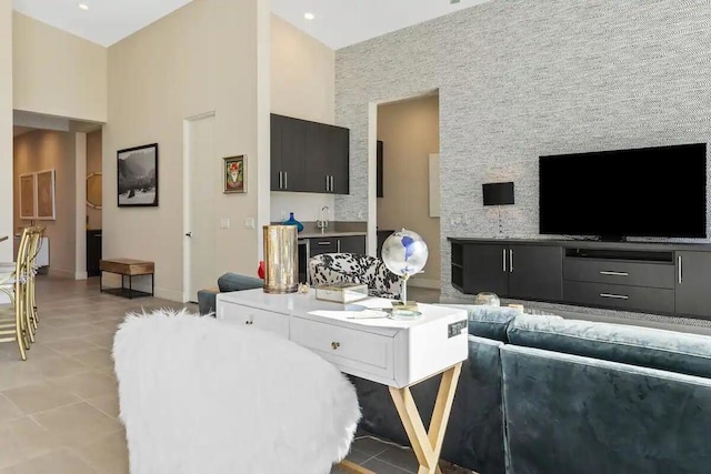 living room featuring a high ceiling and light tile patterned flooring