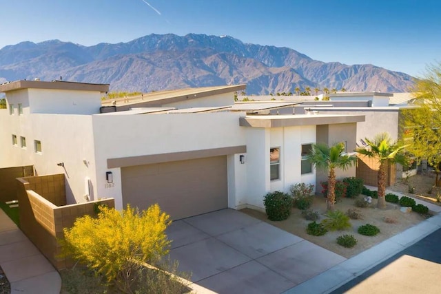 view of front of home featuring a mountain view and a garage