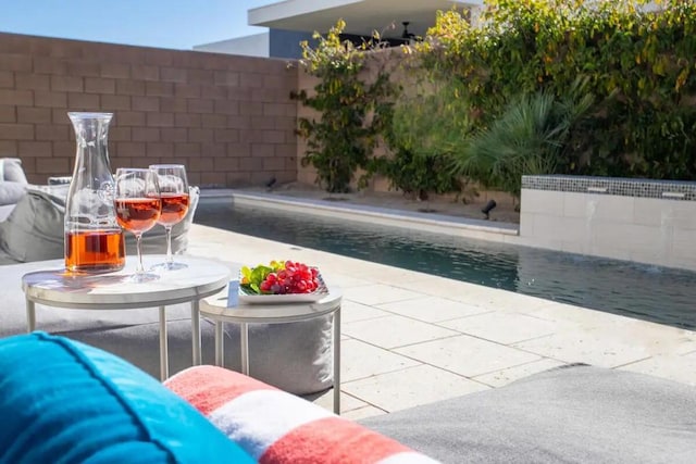 view of pool with an outdoor living space and a patio