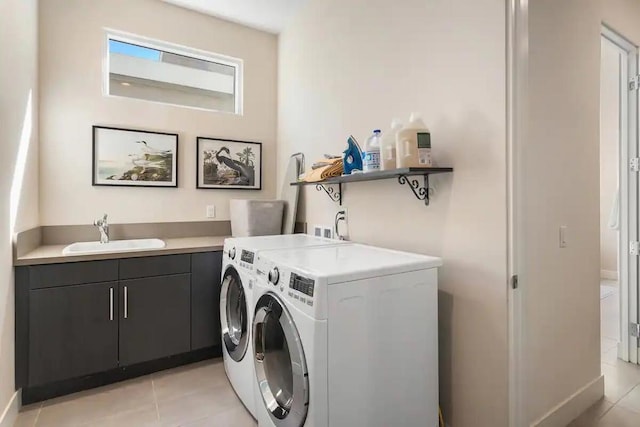 washroom featuring cabinets, sink, separate washer and dryer, and light tile patterned flooring