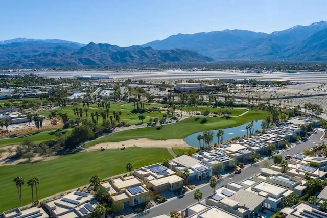 birds eye view of property with a water and mountain view