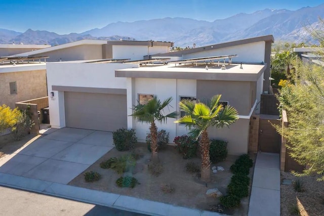 contemporary home with a mountain view and a garage