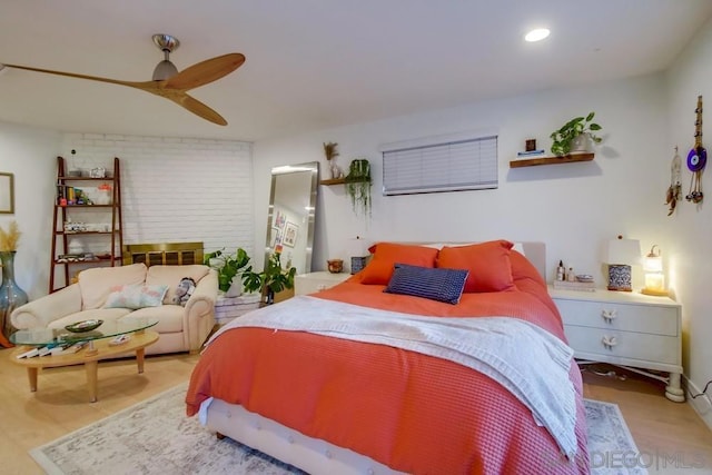 bedroom with ceiling fan and hardwood / wood-style flooring