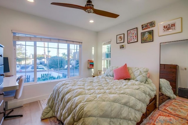 bedroom with ceiling fan and hardwood / wood-style floors