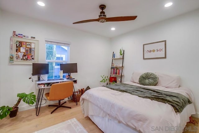 bedroom with ceiling fan and light wood-type flooring