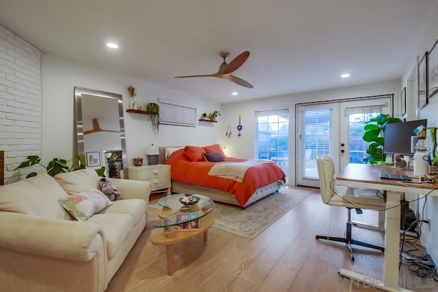 bedroom with light hardwood / wood-style floors, ceiling fan, access to outside, and french doors