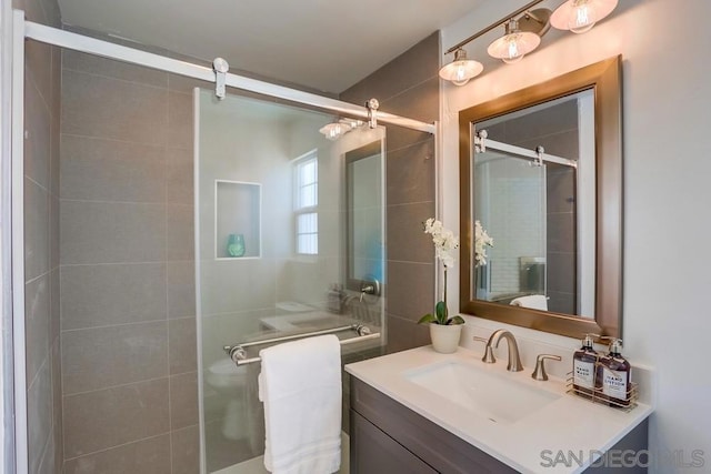 bathroom featuring walk in shower and vanity