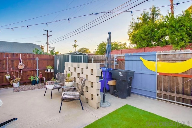 view of patio with a storage unit