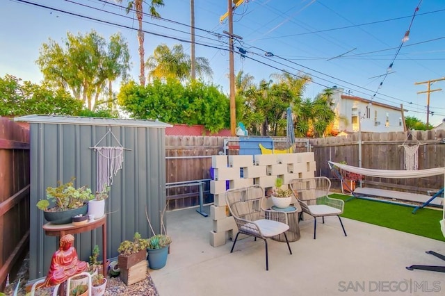 view of patio with a storage unit