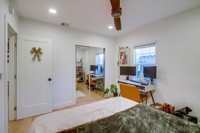 bedroom with ceiling fan, a closet, and light hardwood / wood-style flooring