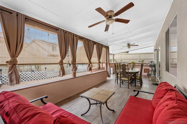 sunroom / solarium with ceiling fan and lofted ceiling