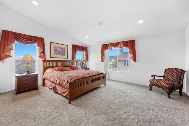 bedroom featuring light carpet and vaulted ceiling