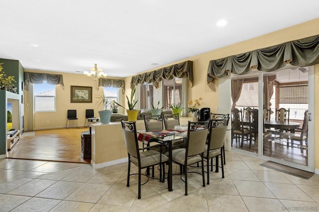 dining area with light tile patterned floors and a notable chandelier