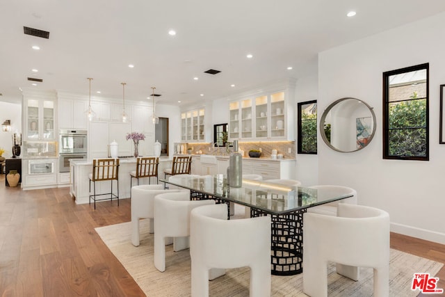 dining space featuring light wood-type flooring