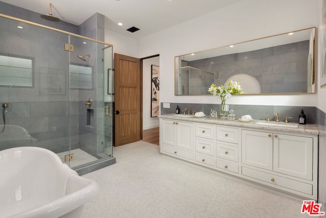 bathroom featuring vanity and separate shower and tub