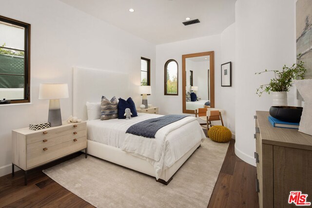 bedroom with hardwood / wood-style flooring