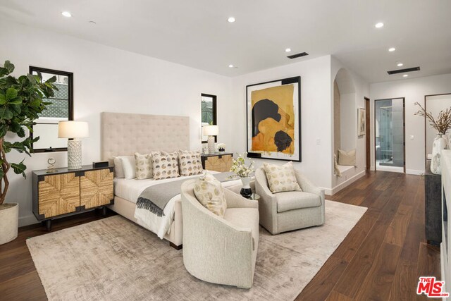 bedroom featuring hardwood / wood-style flooring and connected bathroom