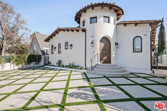 mediterranean / spanish-style home with a patio area