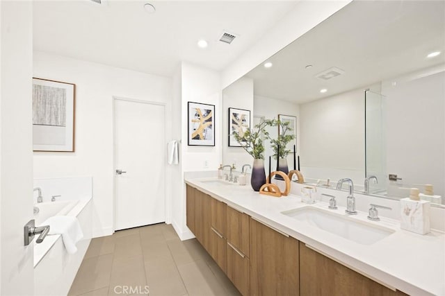 bathroom featuring tile patterned floors, a bathtub, and vanity